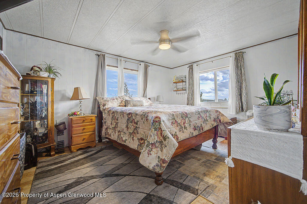723 Barbara Drive Craig, CO 81625 - Photo 35 of 48 a bedroom with a bed and ceiling fan