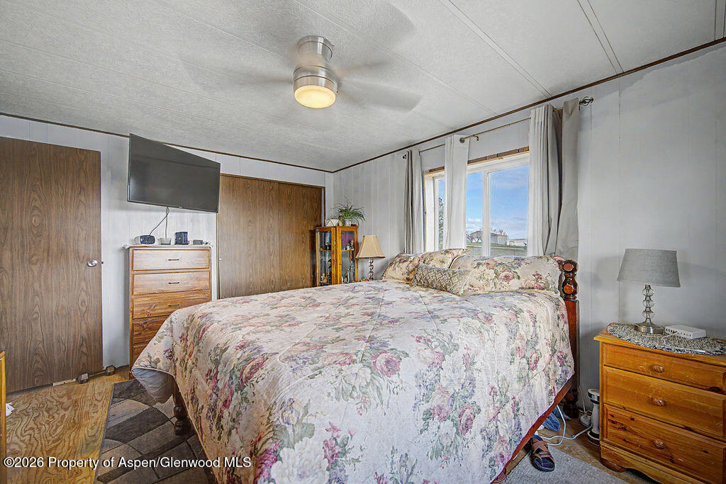 723 Barbara Drive Craig, CO 81625 - Photo 36 of 48 a bedroom with a bed and a lamp with the dresser