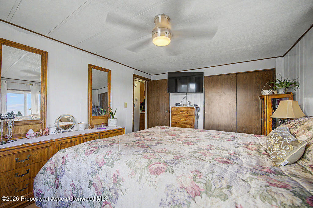 723 Barbara Drive Craig, CO 81625 - Photo 37 of 48 a bedroom with a large bed and a dresser