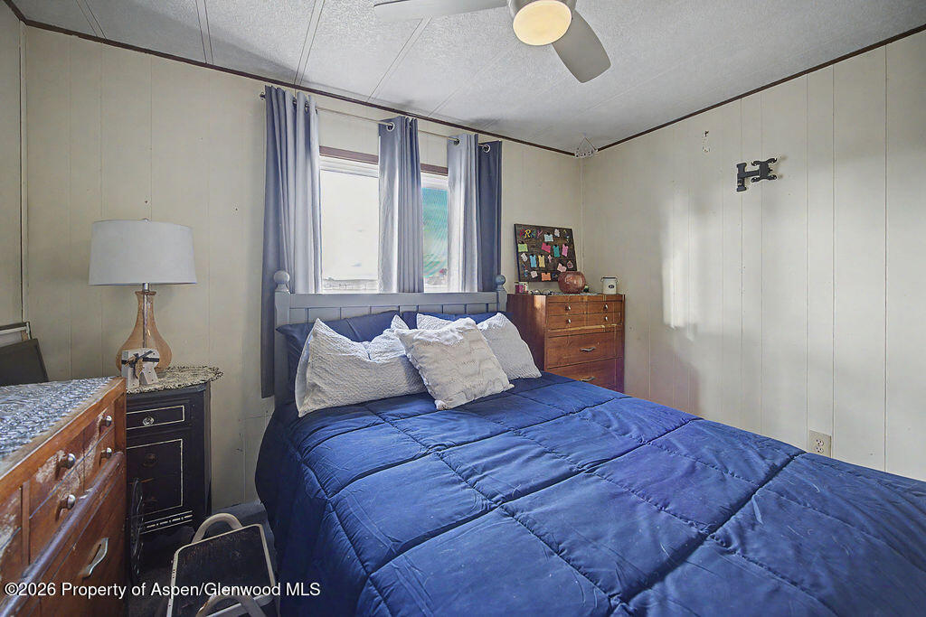 723 Barbara Drive Craig, CO 81625 - Photo 39 of 48 a bedroom with a bed and a lamp on dresser