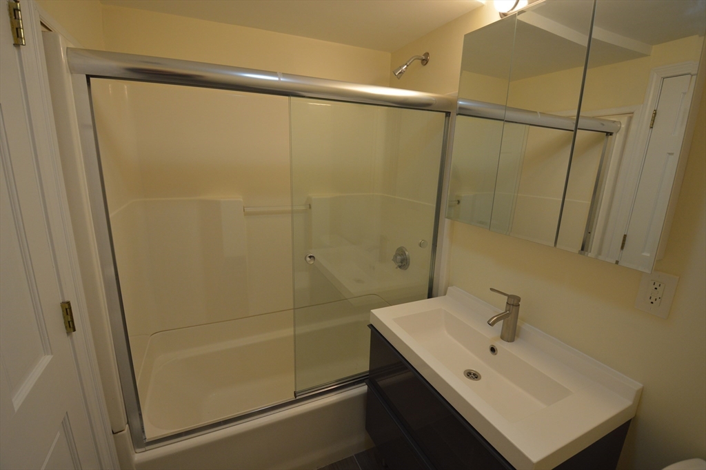 1801 Beacon Street, Unit 2 Brookline, MA 02445 - Photo 12 of 14 a bathroom with a sink a toilet and shower