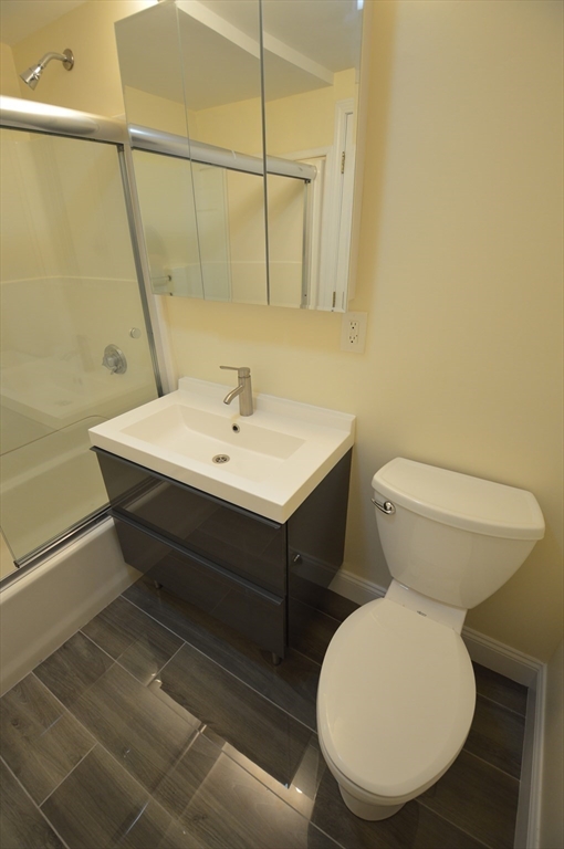 1801 Beacon Street, Unit 2 Brookline, MA 02445 - Photo 14 of 14 a bathroom with a toilet sink and mirror