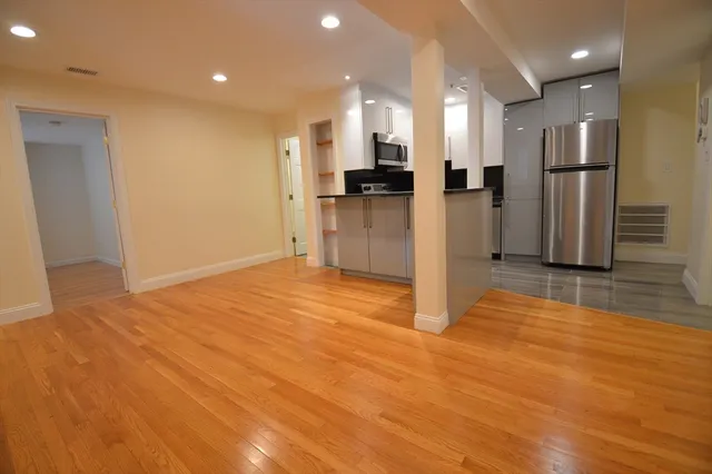 a view of a kitchen with refrigerator and a stove