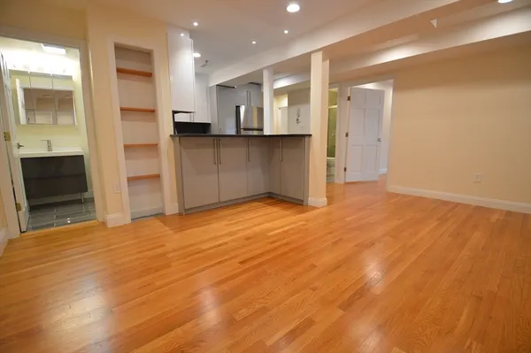 a view of a kitchen with refrigerator and an oven