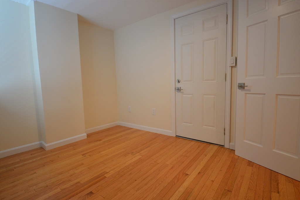 1801 Beacon Street, Unit 2 Brookline, MA 02445 - Photo 7 of 14 a view of empty room with wooden floor