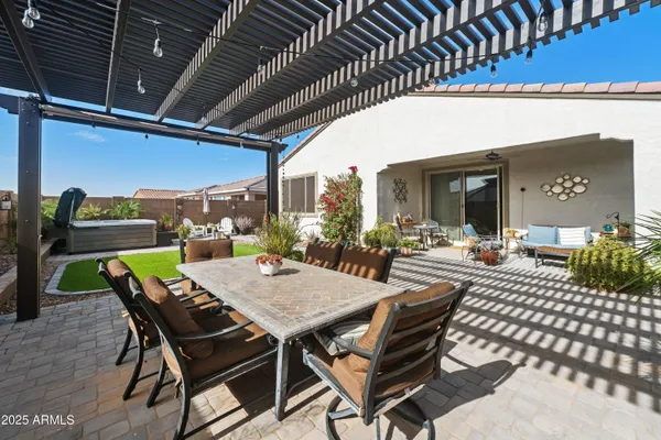 a view of a house with backyard and sitting area