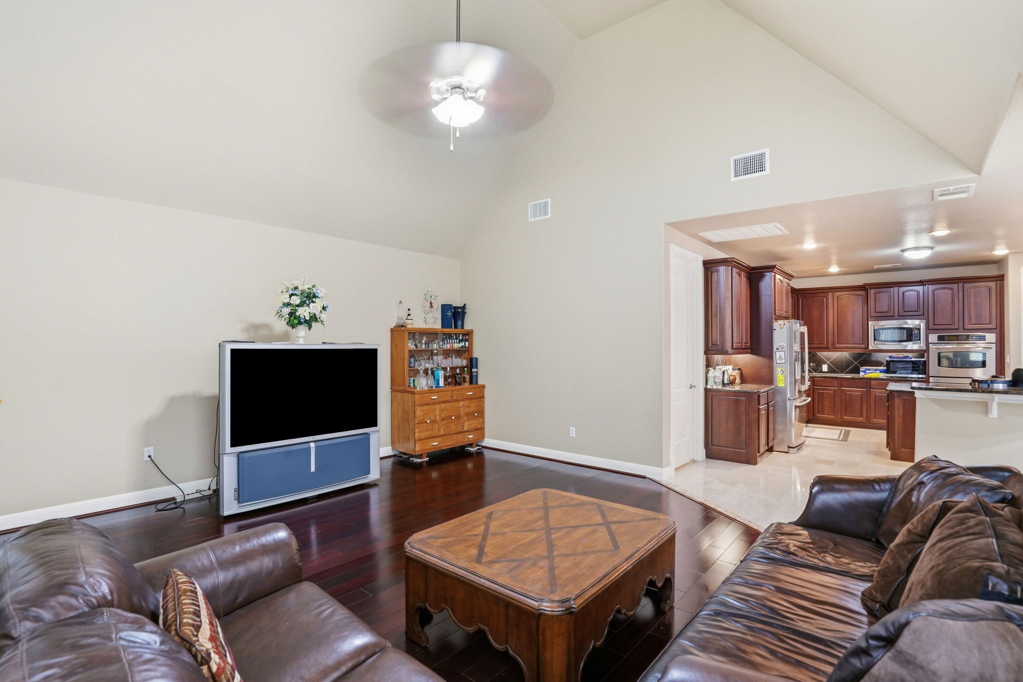 222 Vailco Lane Austin, TX 78738 - Photo 14 of 39 Vaulted ceiling main living area featuring dark wood-finish flooring, a ceiling fan, and recessed lighting