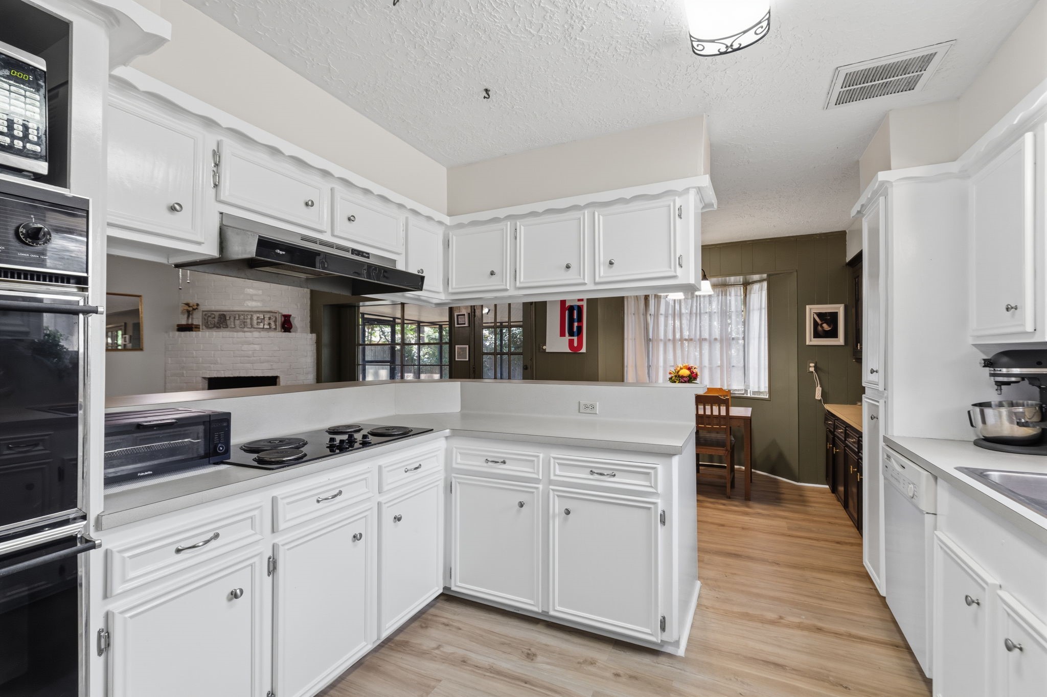 9618 Rannock Way Spring, TX 77379 - Photo 12 of 24 a kitchen with granite countertop white cabinets and white appliances
