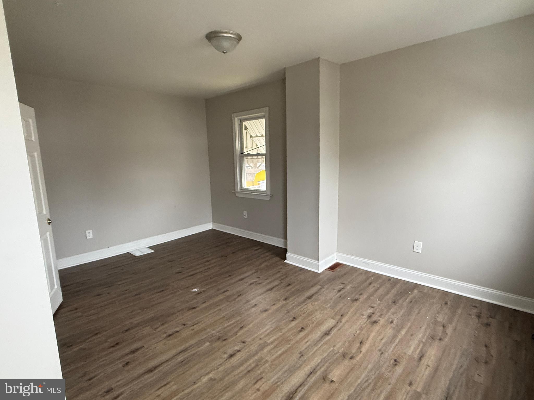 232 West Union Street Burlington, NJ 08016 - Photo 11 of 13 an empty room with wooden floor and windows