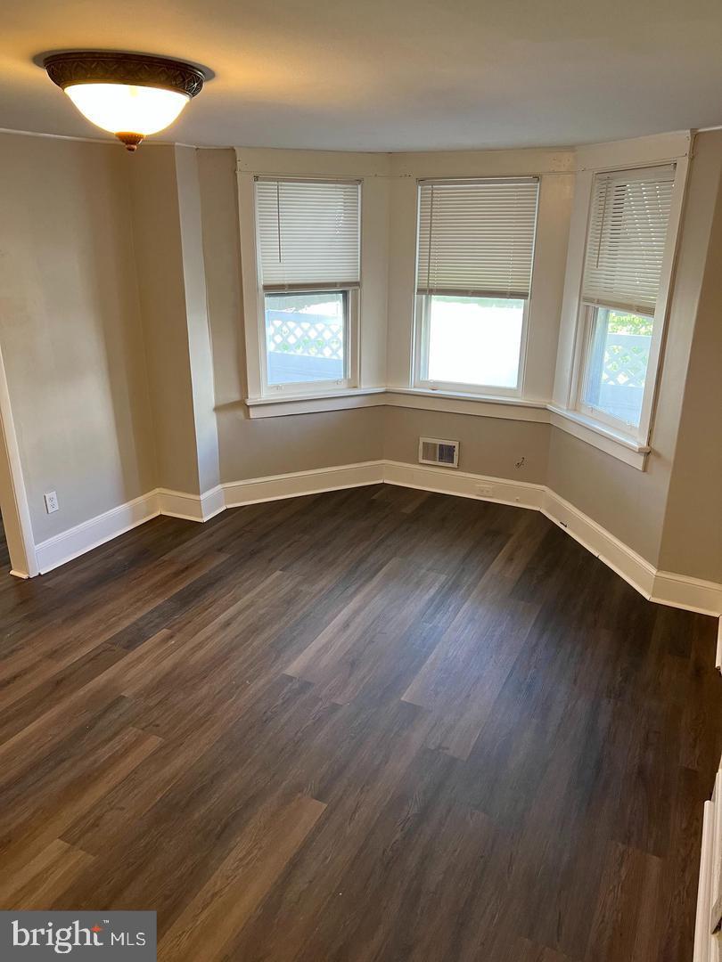 232 West Union Street Burlington, NJ 08016 - Photo 2 of 13 an empty room with wooden floor and windows