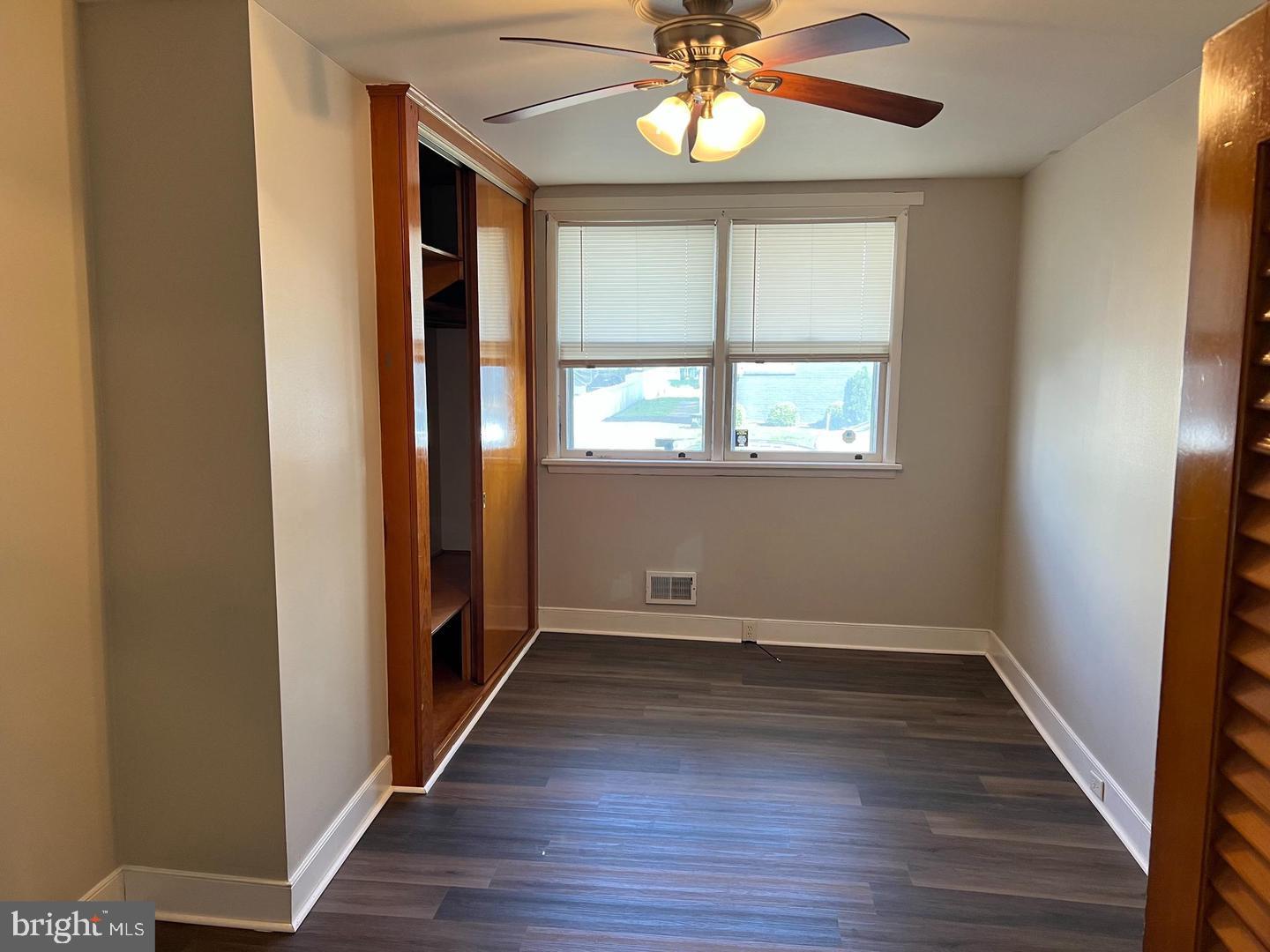 232 West Union Street Burlington, NJ 08016 - Photo 3 of 13 an empty room with wooden floor chandelier and windows
