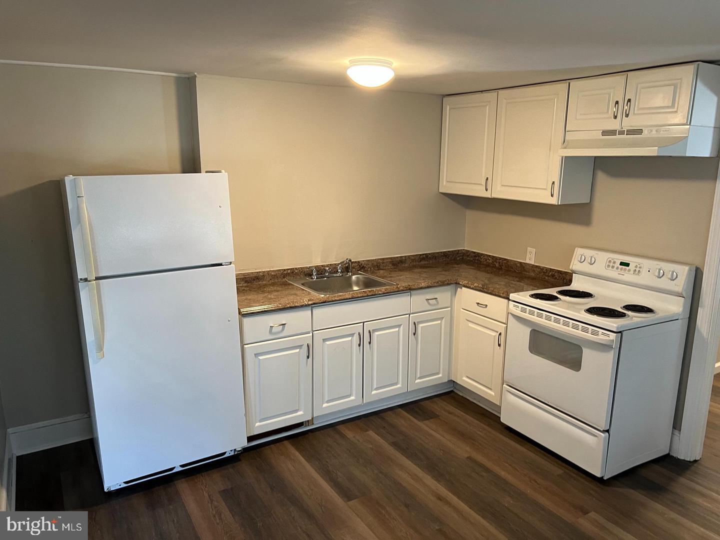 232 West Union Street Burlington, NJ 08016 - Photo 5 of 13 a white kitchen with wooden floor
