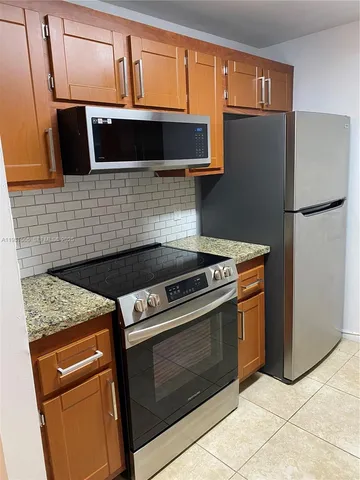 a stove top oven sitting inside of a kitchen