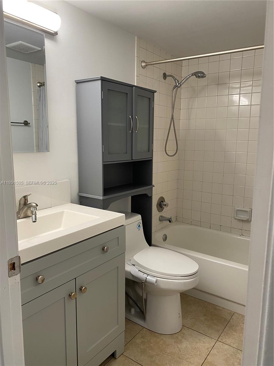 301 Southwest 135th Avenue, Unit 209C Pembroke Pines, FL 33027 - Photo 10 of 14 a bathroom with a sink toilet and shower