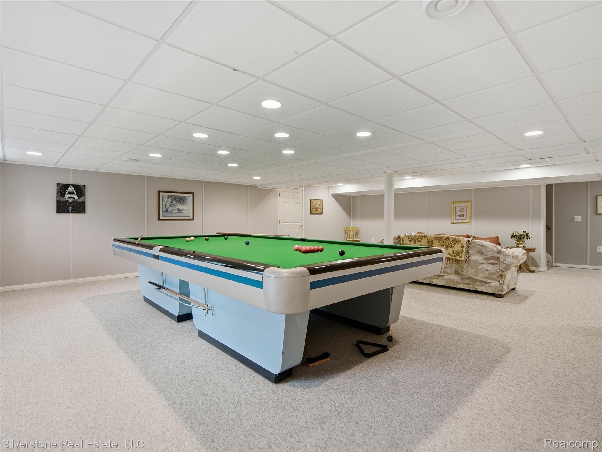 6577 Edith Court Troy, MI 48085 - Photo 48 of 61 Spacious finished basement featuring recessed lighting, a drop ceiling, light-colored carpeting, painted panel walls, and a dedicated area for recreation