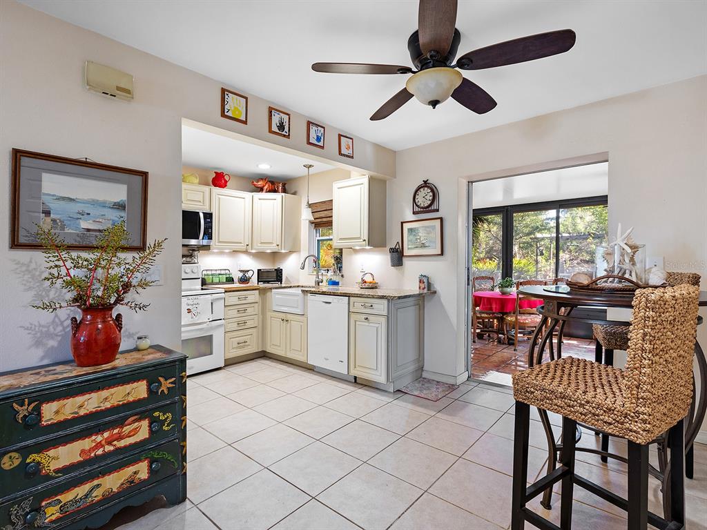 3932 Ragen Street North Port, FL 34287 - Photo 16 of 40 a kitchen that has a lot of cabinets in it and wooden floors