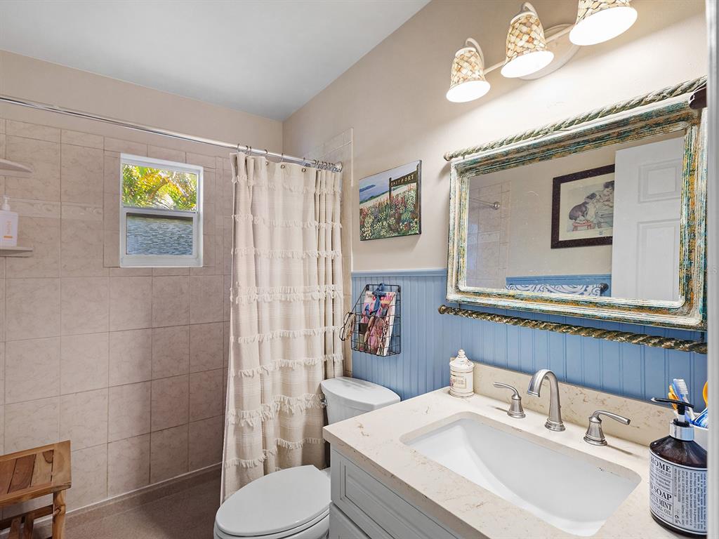 3932 Ragen Street North Port, FL 34287 - Photo 27 of 40 a bathroom with a sink a toilet and shower