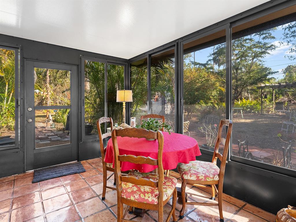 3932 Ragen Street North Port, FL 34287 - Photo 29 of 40 a view of a dining room with furniture large windows and wooden floor