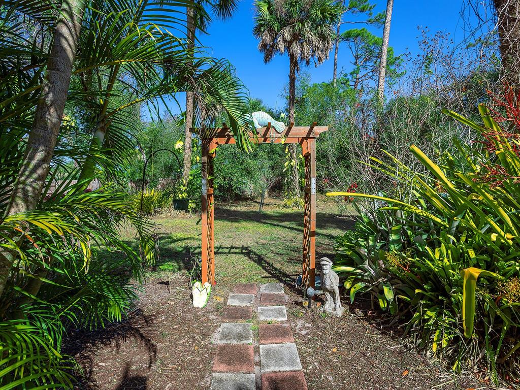 3932 Ragen Street North Port, FL 34287 - Photo 31 of 40 a view of a yard with plants and trees