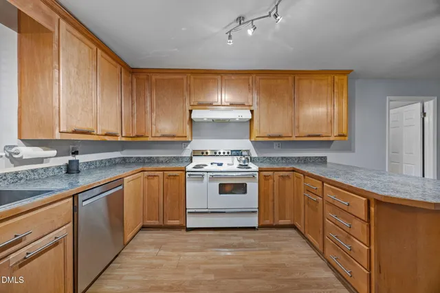 a kitchen with stainless steel appliances granite countertop a stove and a sink