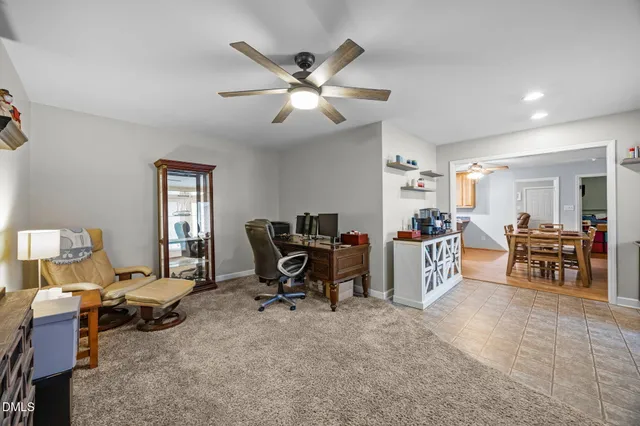 a view of a livingroom with workspace and a window