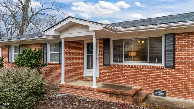 a view of a brick house with many windows