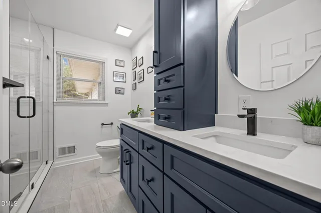 a bathroom with a sink a toilet and a mirror