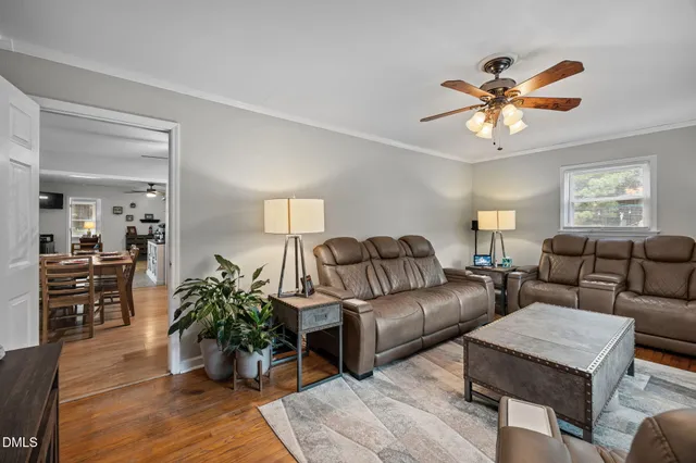 a living room with furniture and wooden floor