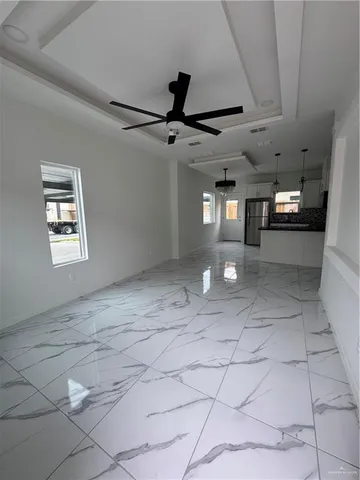 a view of a hallway with chandelier