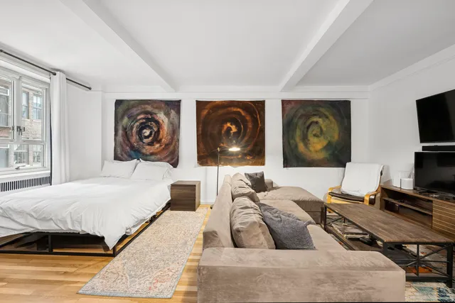 a bedroom with a bed and a couch