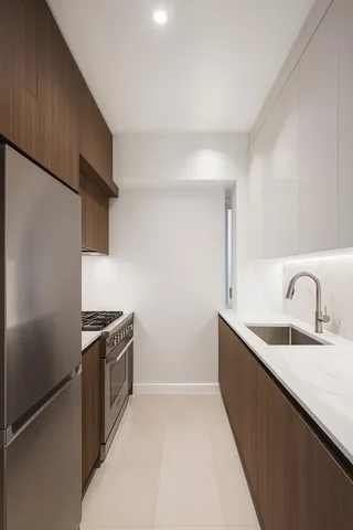 a kitchen with stainless steel appliances granite countertop a sink and a refrigerator