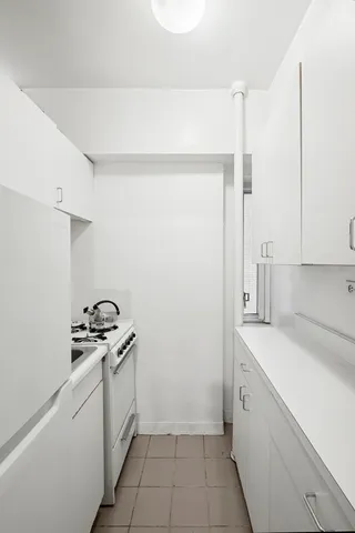 a room with a sink and cabinets