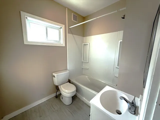 a bathroom with a toilet a sink and bathtub