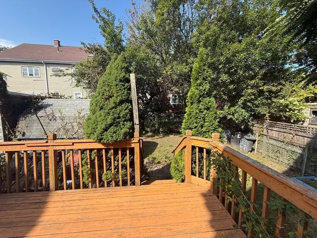 a view of a wooden deck and trees