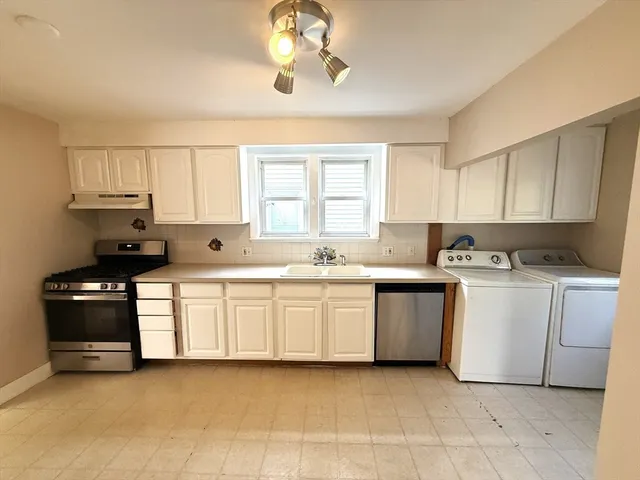 a kitchen with a white cabinets and white appliances