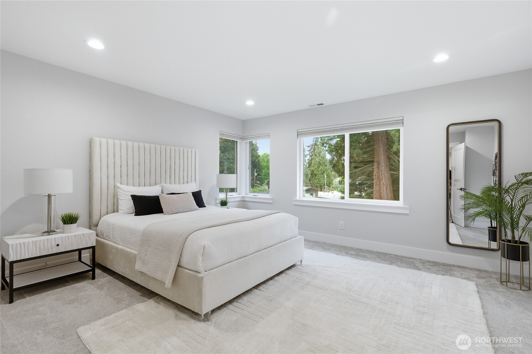 719 Edmonds Way Edmonds, WA 98020 - Photo 18 of 40 a spacious bedroom with a bed lamp and windows