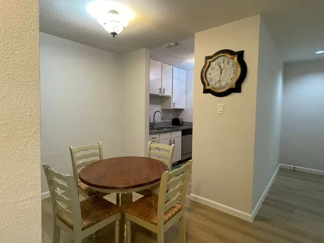 a view of a kitchen with a table and a chair
