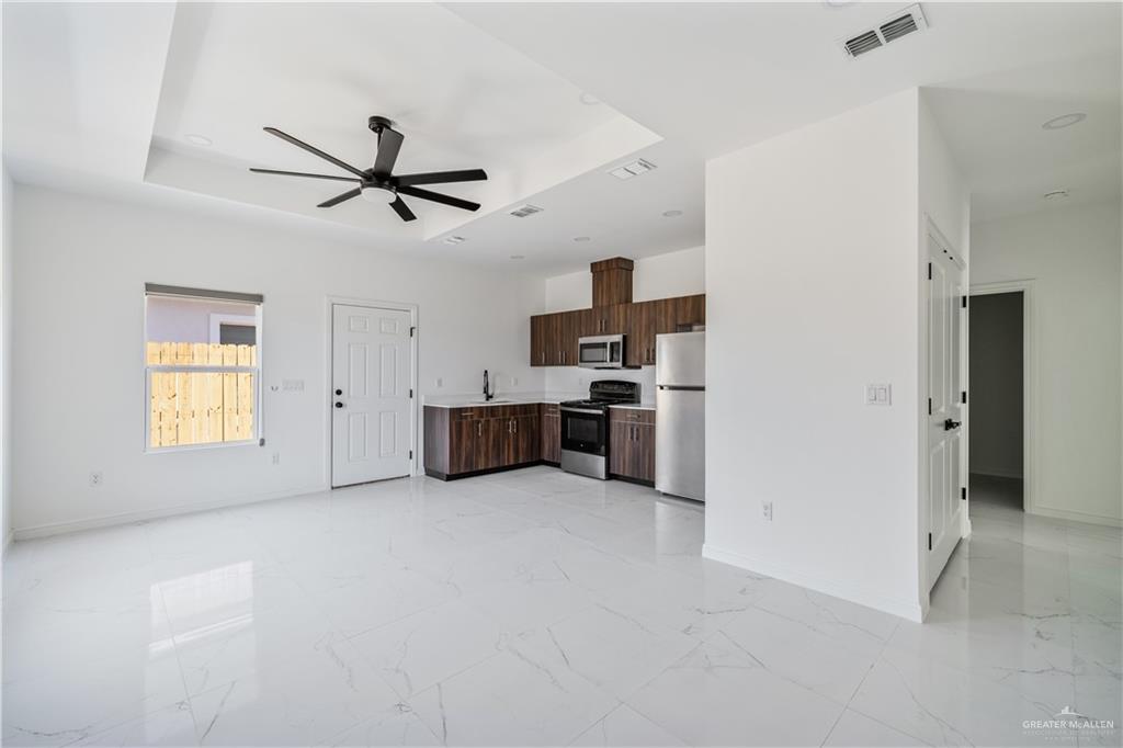 5322 Vision Street Rio Grande City, TX 78582 - Photo 12 of 19 a view of a livingroom with a kitchen space stove a sink and a window