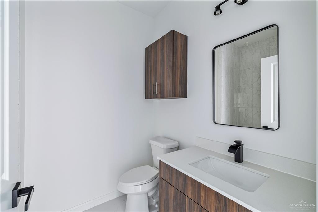 5322 Vision Street Rio Grande City, TX 78582 - Photo 18 of 19 a bathroom with a toilet a sink and mirror