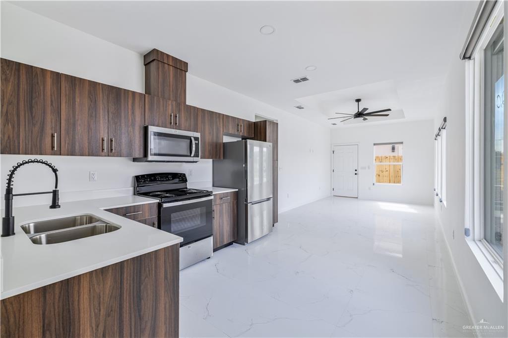 5322 Vision Street Rio Grande City, TX 78582 - Photo 4 of 19 a kitchen with a sink a stove and refrigerator