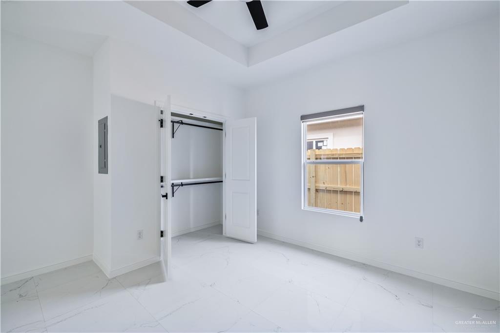 5322 Vision Street Rio Grande City, TX 78582 - Photo 6 of 19 an empty room with windows and refrigerator