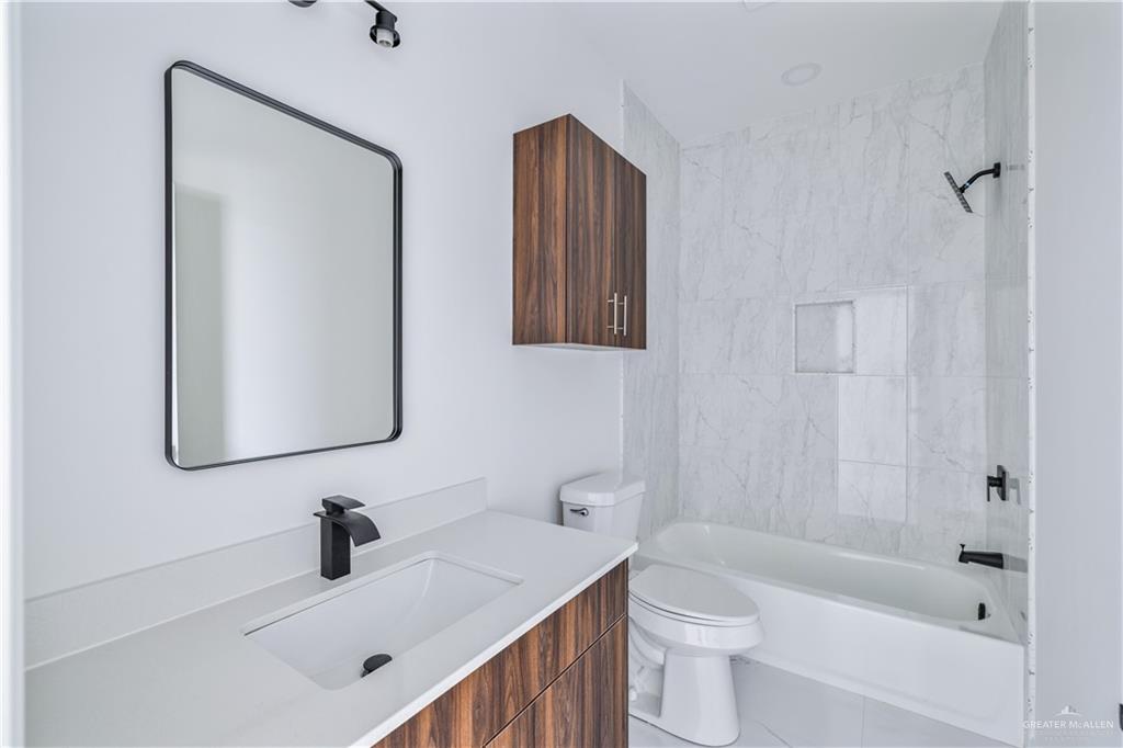 5322 Vision Street Rio Grande City, TX 78582 - Photo 9 of 19 a bathroom with a sink a toilet and shower