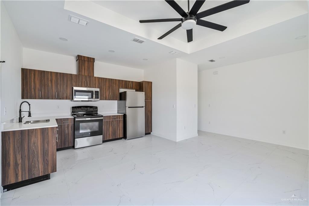 5322 Vision Street Rio Grande City, TX 78582 - Photo 10 of 19 a kitchen with stainless steel appliances a stove sink and refrigerator