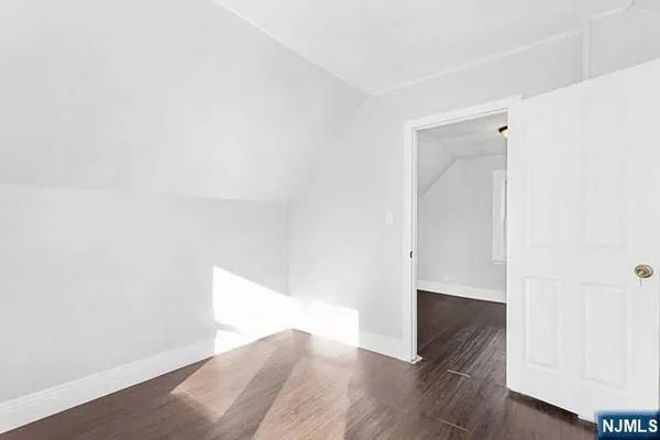 a view of hallway with wooden floor