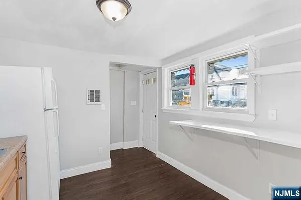 a view of a livingroom with wooden floor and window