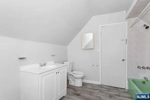 a view of bathroom with a sink and mirror