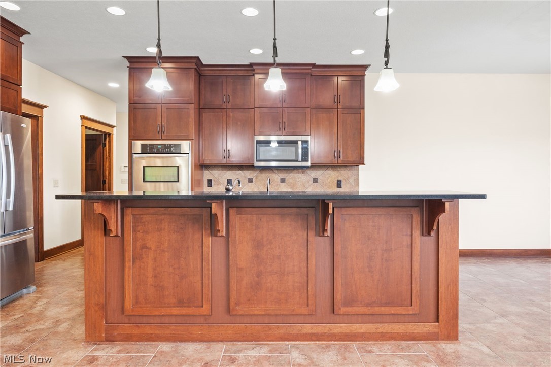 6925 River Styx Road Medina, OH 44256 - Photo 13 of 49 Kitchen island with a dark countertop and integrated corbels