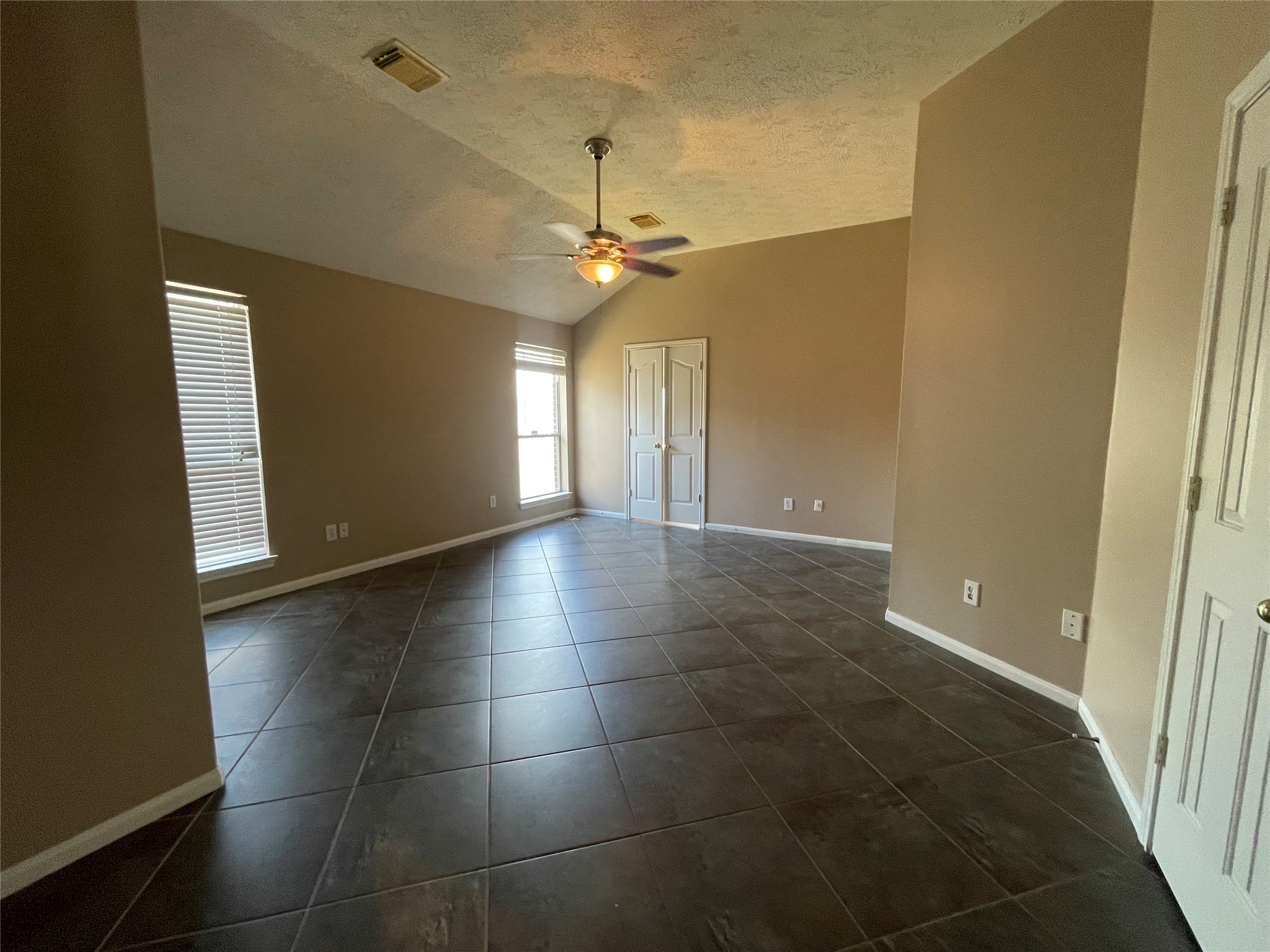22911 Sebastian Drive Porter, TX 77365 - Photo 16 of 23 a view of a livingroom with a chandelier fan and windows