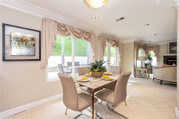 a dining room with furniture and window