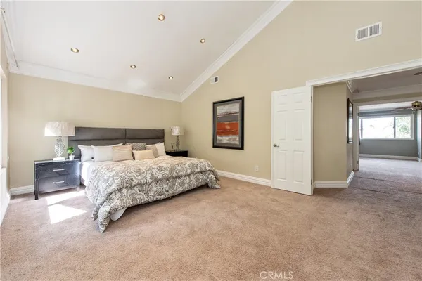 a bedroom with a bed and a lamp